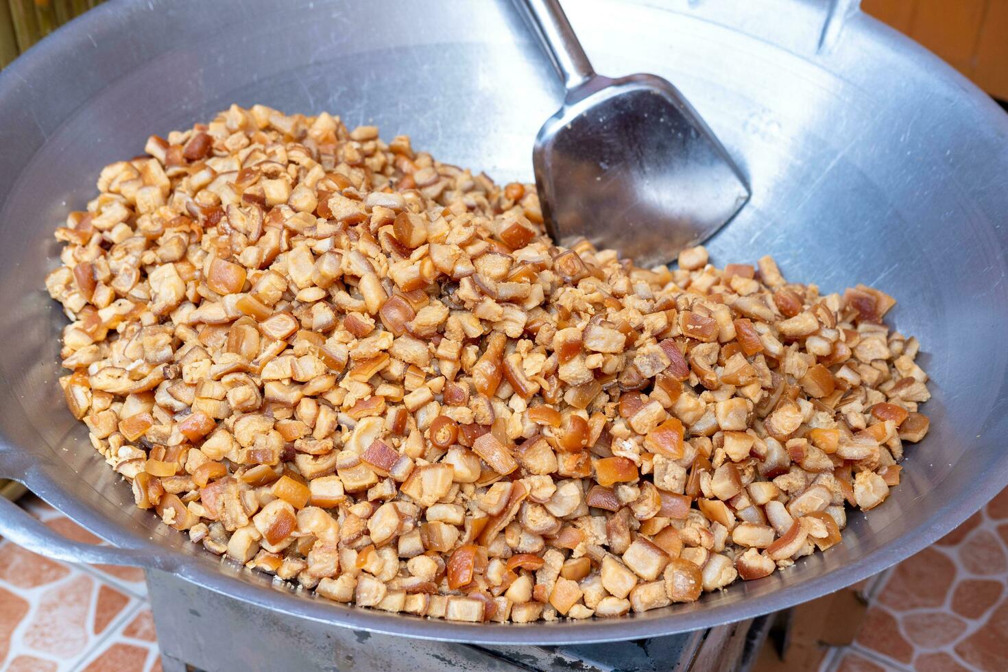 Sliced pork and fat being cooked in a large pan. photo