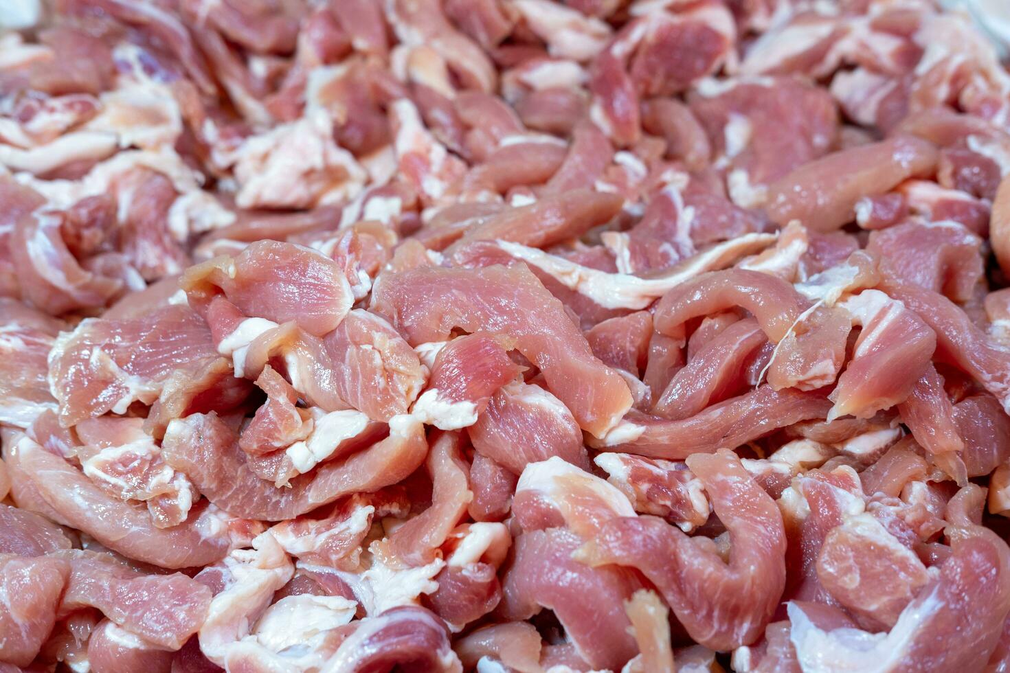 Fresh pork pieces that are dried in the sun are prepared for cooking. photo