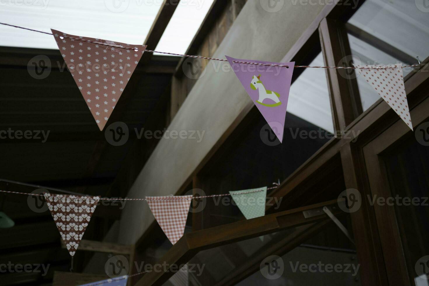 Festive colorful flags decorated on wooden architecture photo