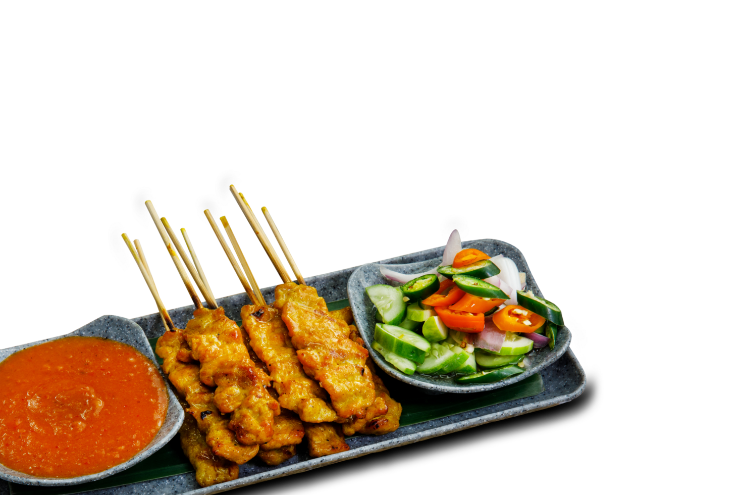 Pork Satay on plate. Grilled pork served with peanut dipping sauce,toasted bread and sweet sour sauce decorated with cucumber,onion and chili. One of the best Thai street food. png