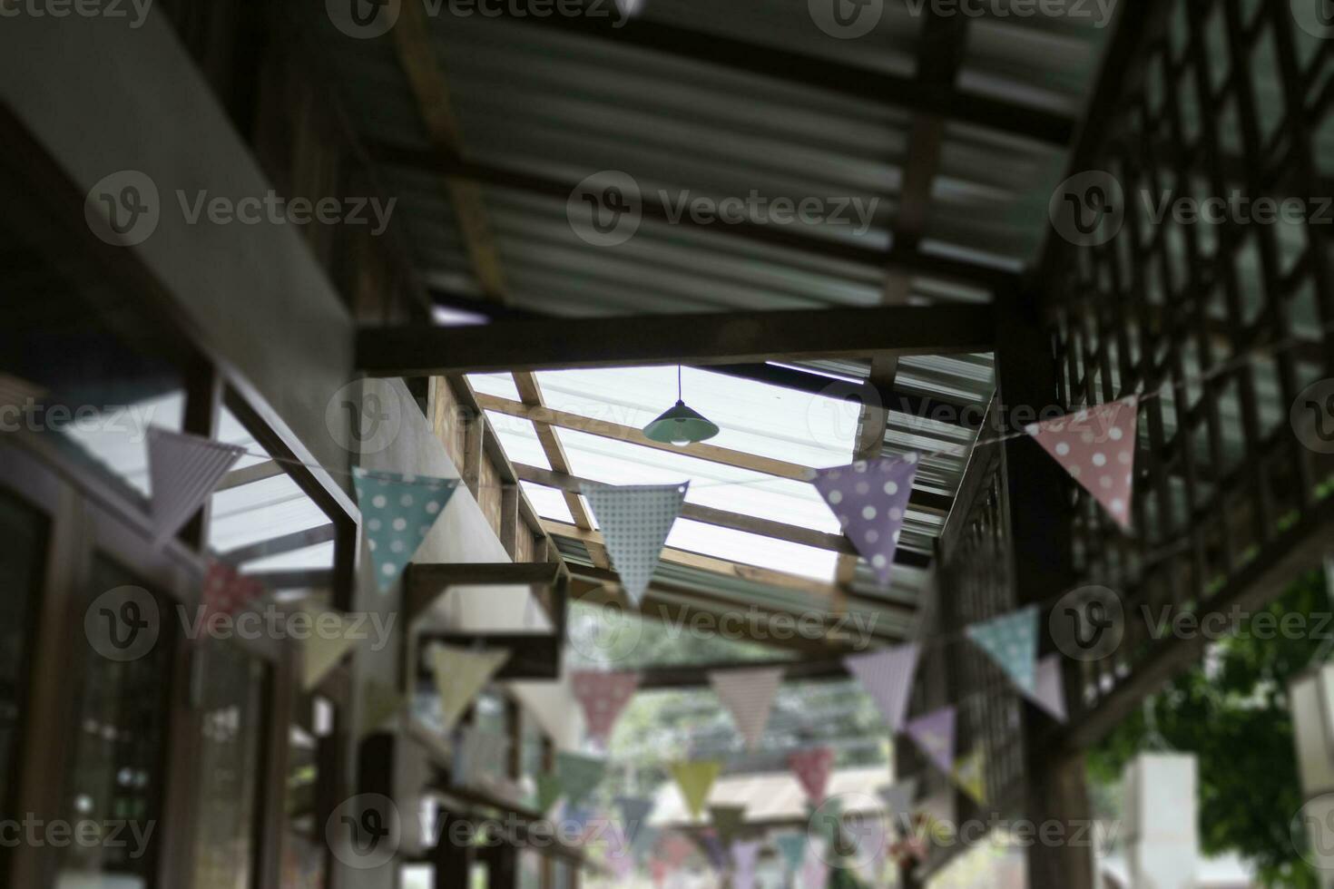 Festive colorful flags decorated on wooden architecture photo