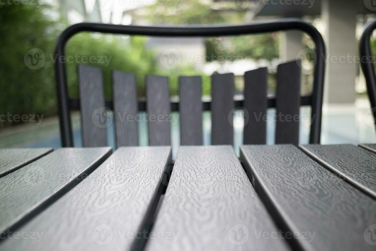 Empty table top and blurred swimming pool in tropical resort photo