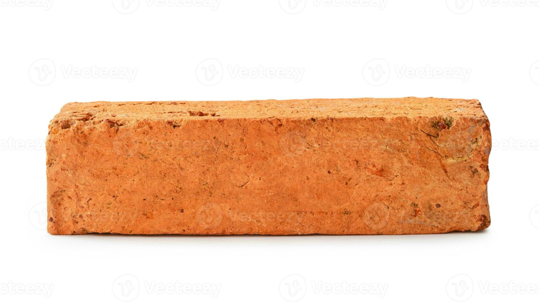 Single cracked old red or orange brick isolated on white background with clipping path photo