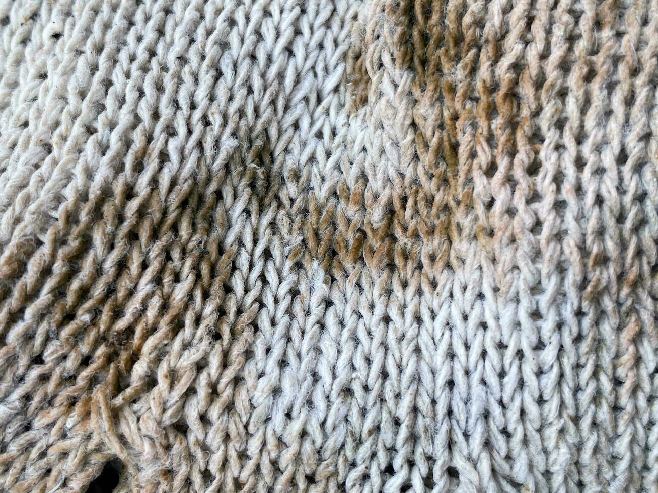 texture of a knitted fabric, a background of a white wool with a pattern of wool photo