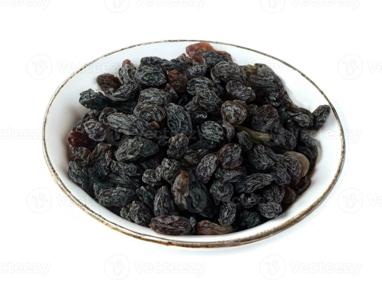 dried raisins on a plate on a white background photo