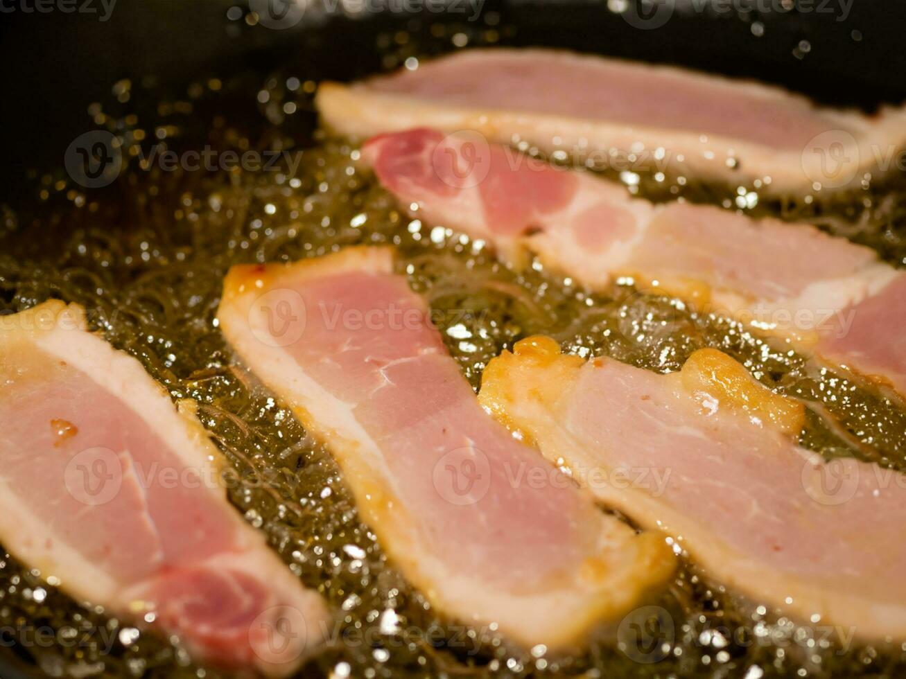 fried bacon in a frying pan. close up photo