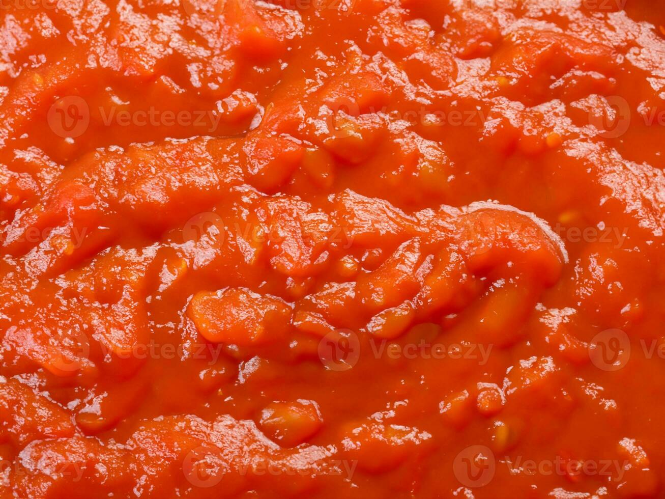 red tomato sauce with garlic in pan photo