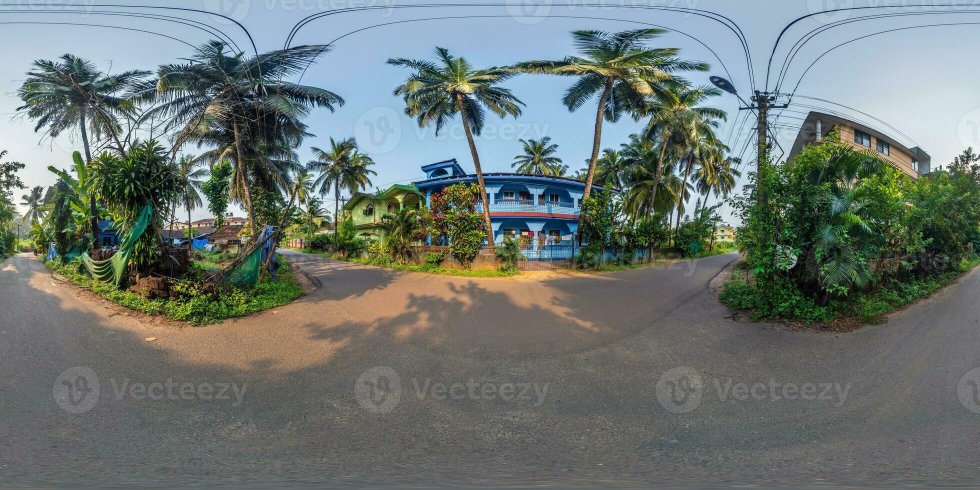 full seamless spherical hdr 360 panorama view among green street with cottages, villas and coconut trees in an indian tropic village in equirectangular projection, ready for VR AR virtual reality photo