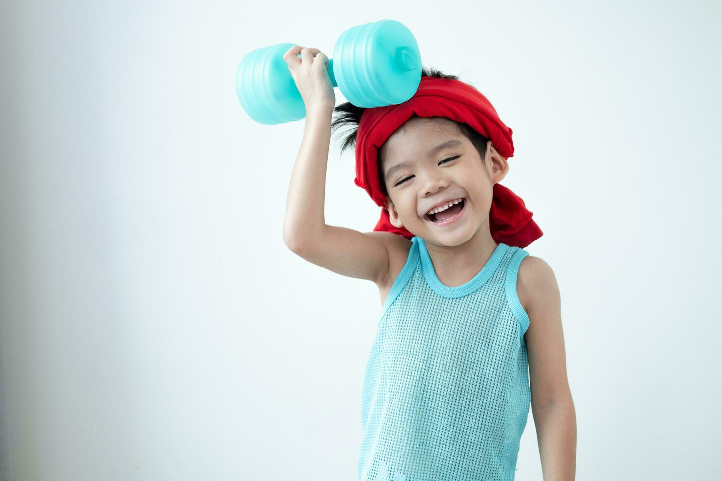 Asian boy in tank top doing exercise And there was a sweat towel on his head. photo