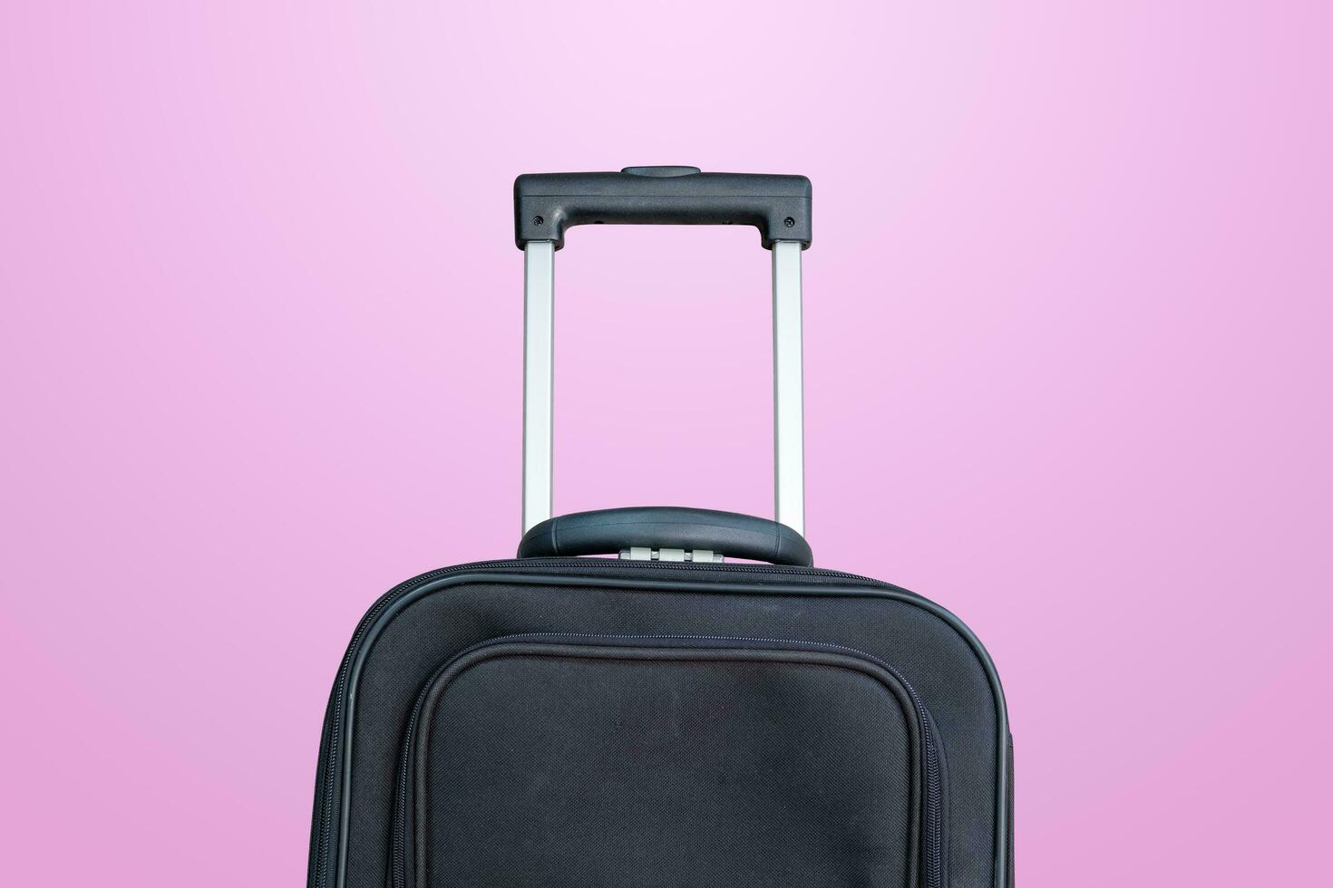 black travel bag on a pink background photo