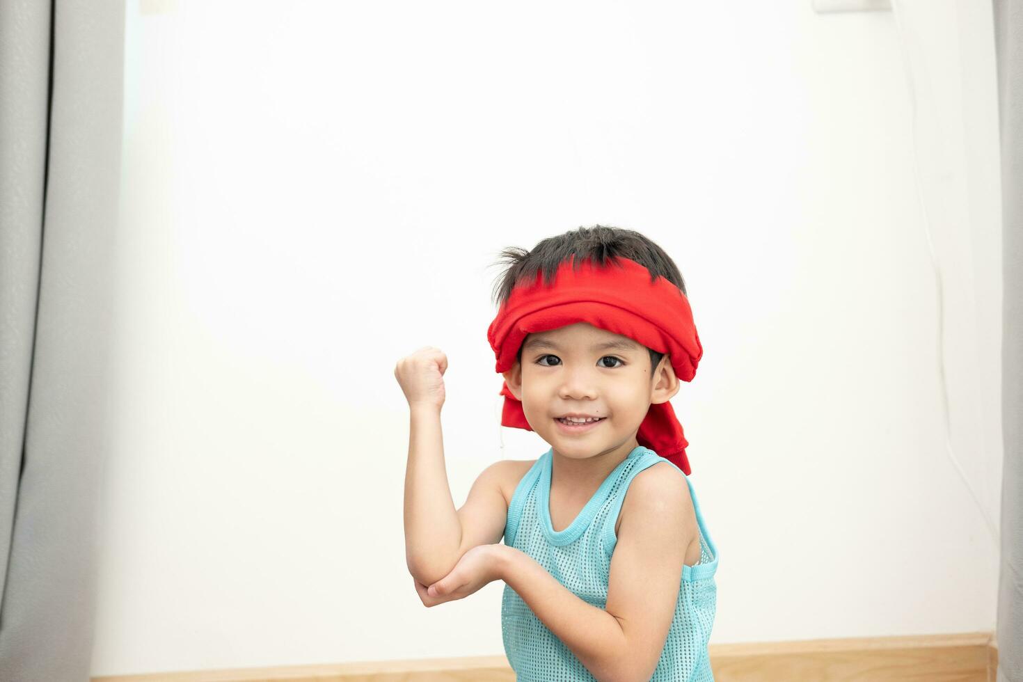 Asian boy in tank top doing exercise And there was a sweat towel on his head. photo