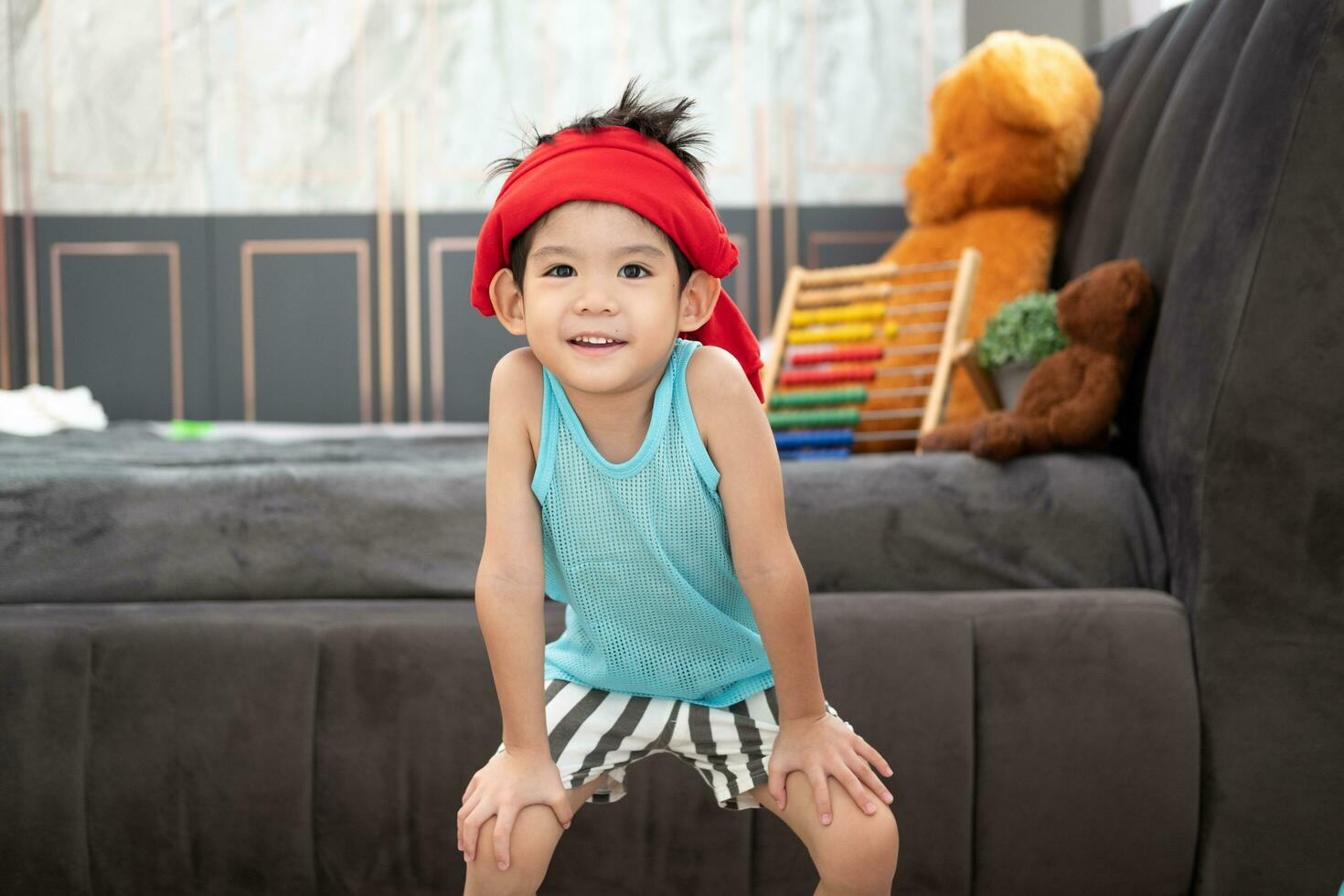 Asian boy in tank top doing exercise And there was a sweat towel on his head. photo