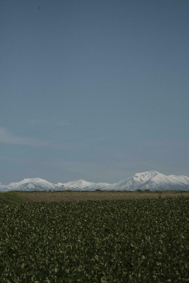 clouds over the mountains and farms photo