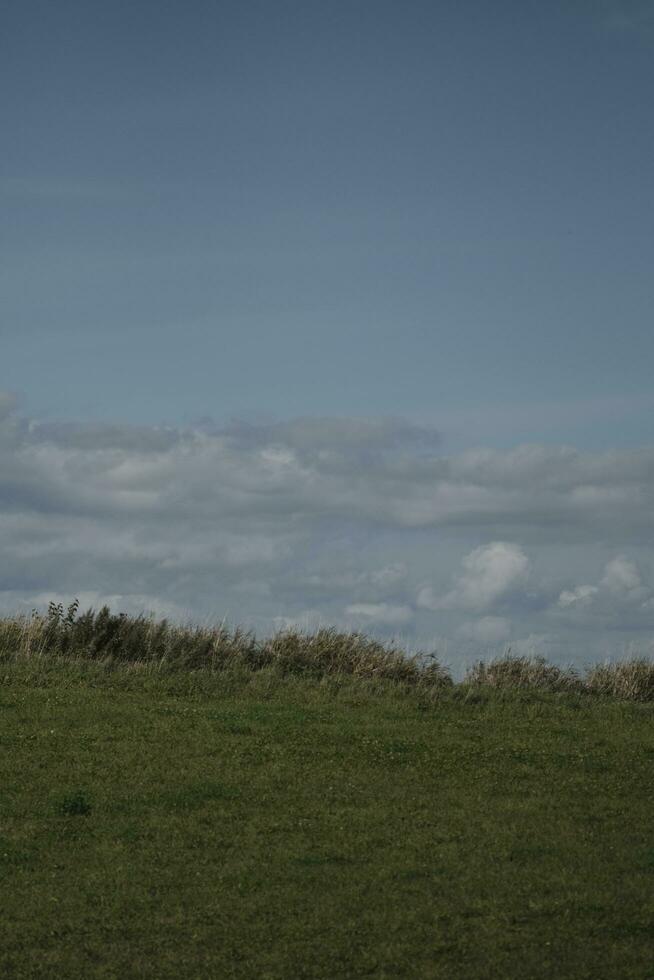 clouds over the mountains and farms photo