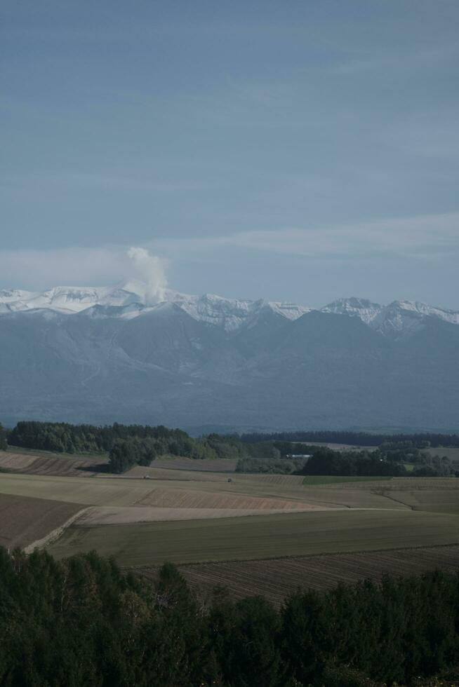 clouds over the mountains and farms photo