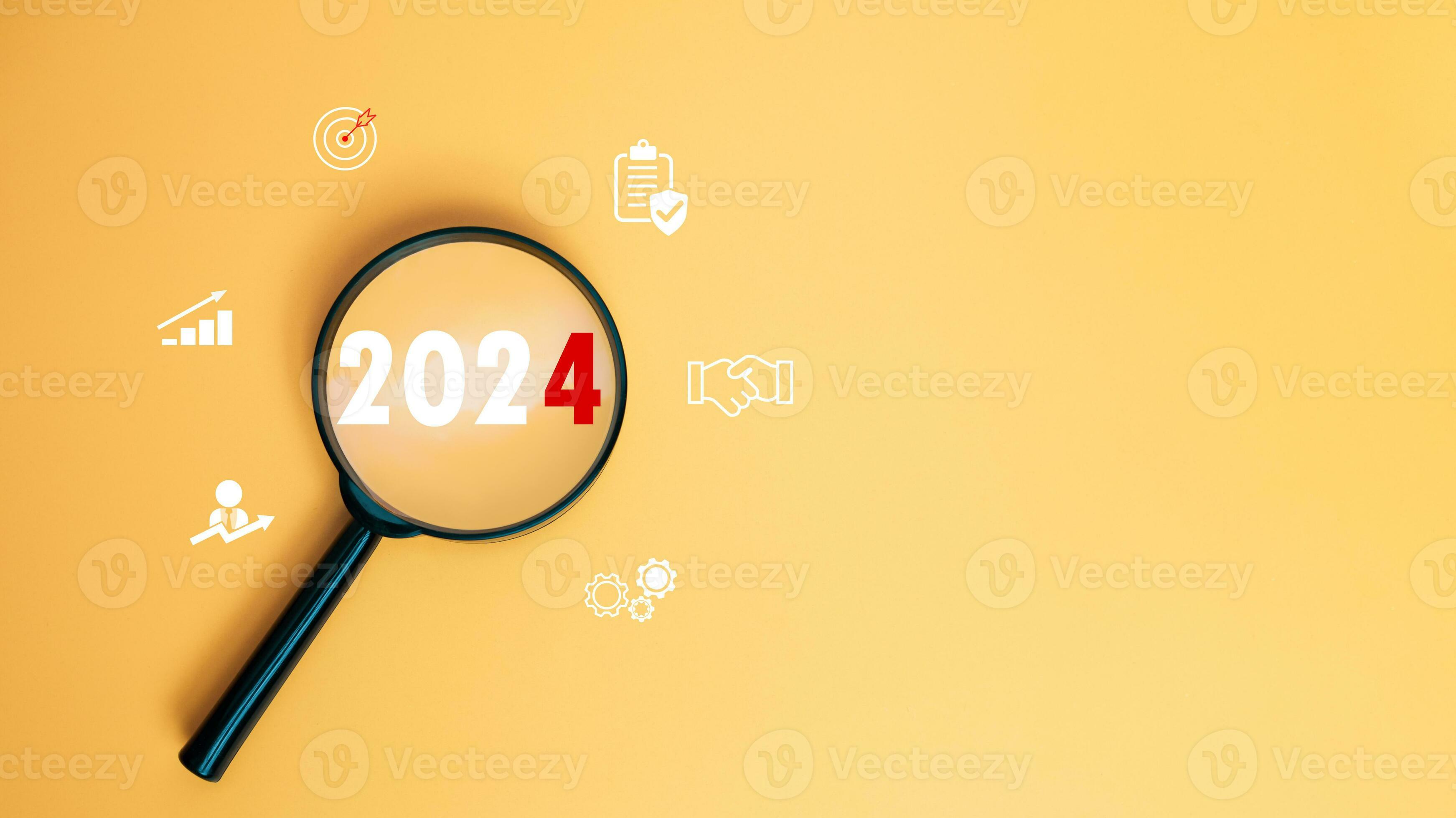 Magnifying glass focused on letter 2024 on yellow background