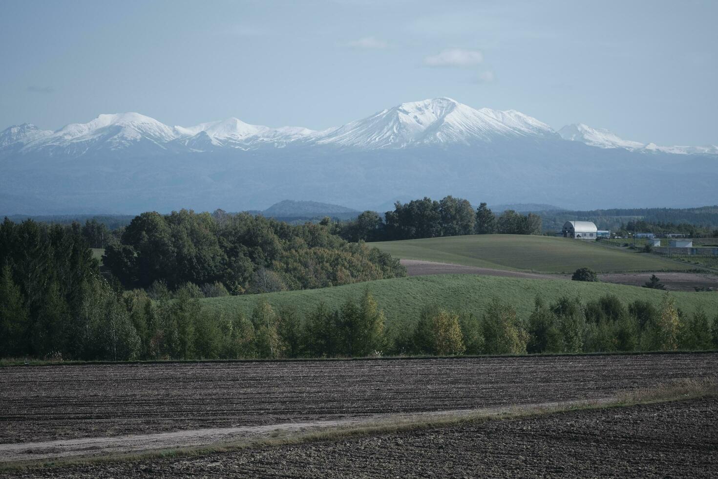 clouds over the mountains and farms photo