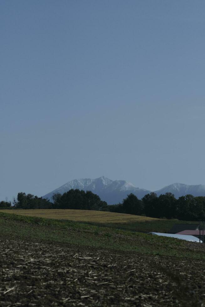 clouds over the mountains and farms photo