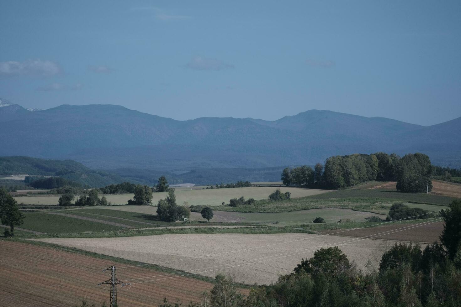 clouds over the mountains and farms photo