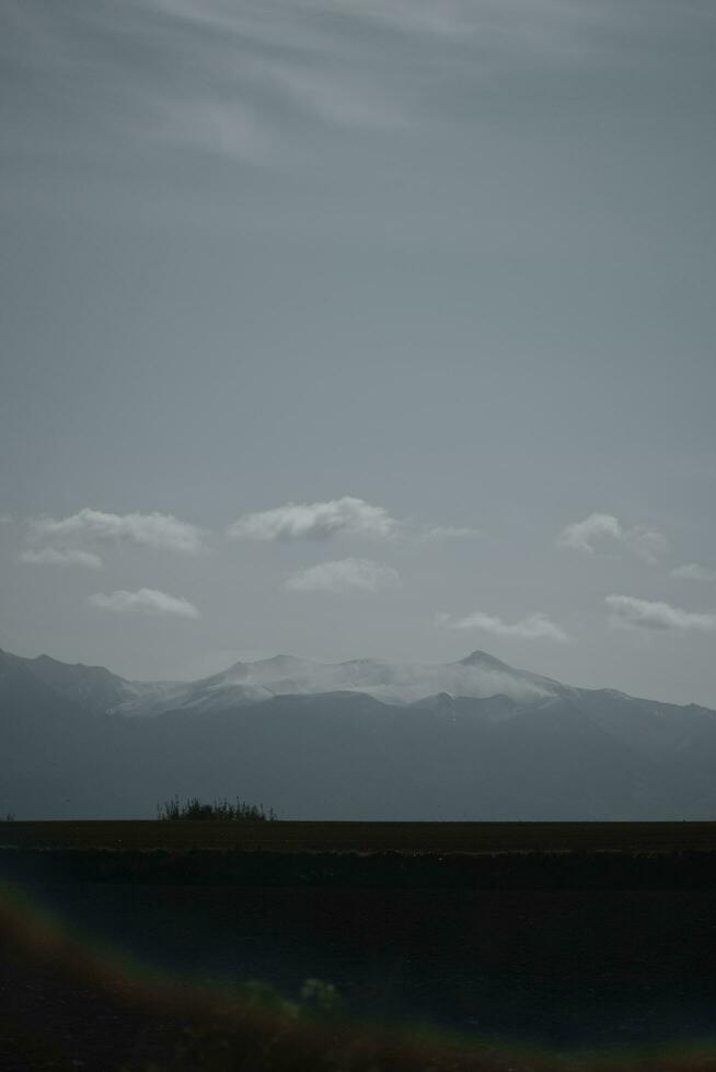 clouds over the mountains and farms photo