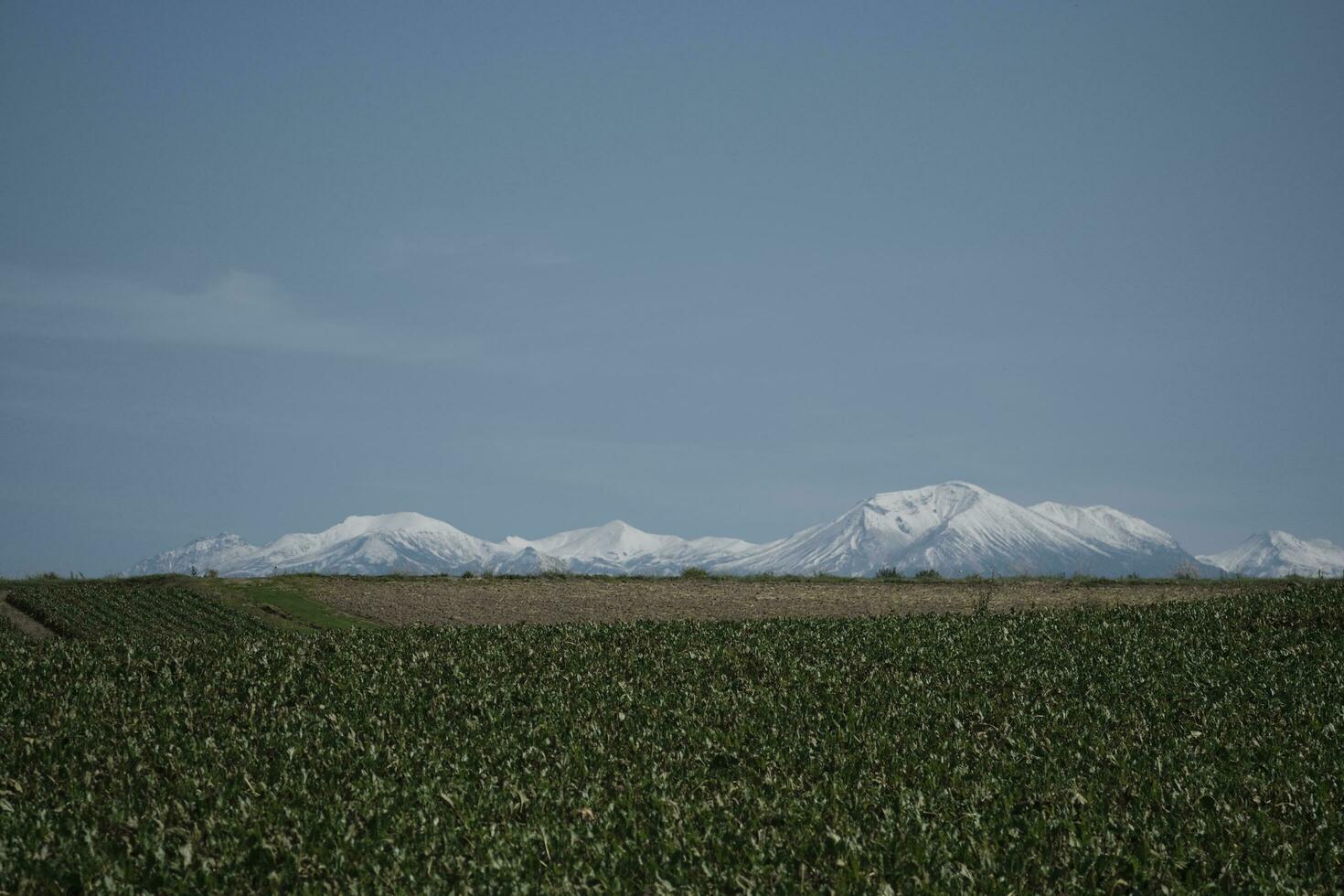 clouds over the mountains and farms photo