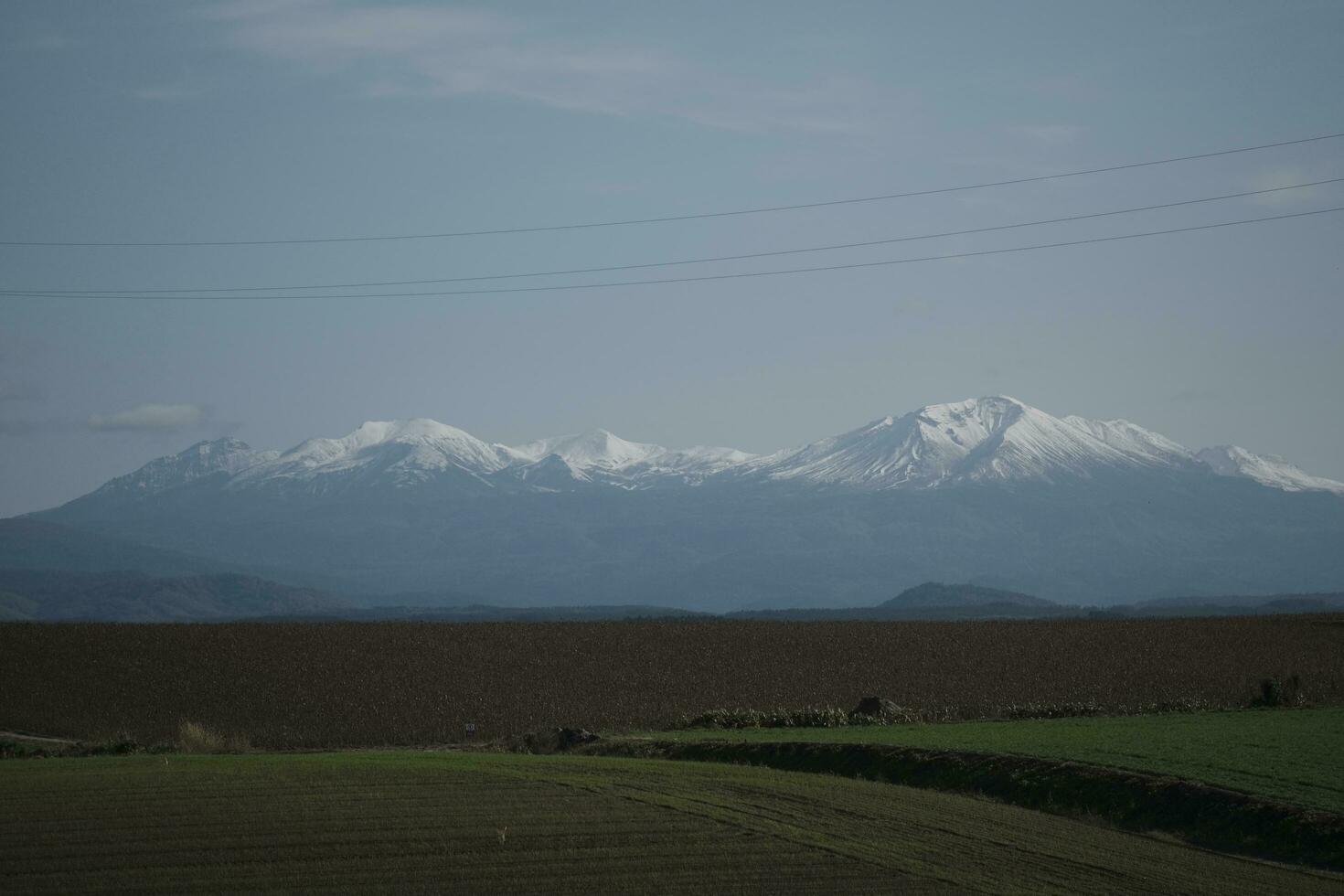 clouds over the mountains and farms photo