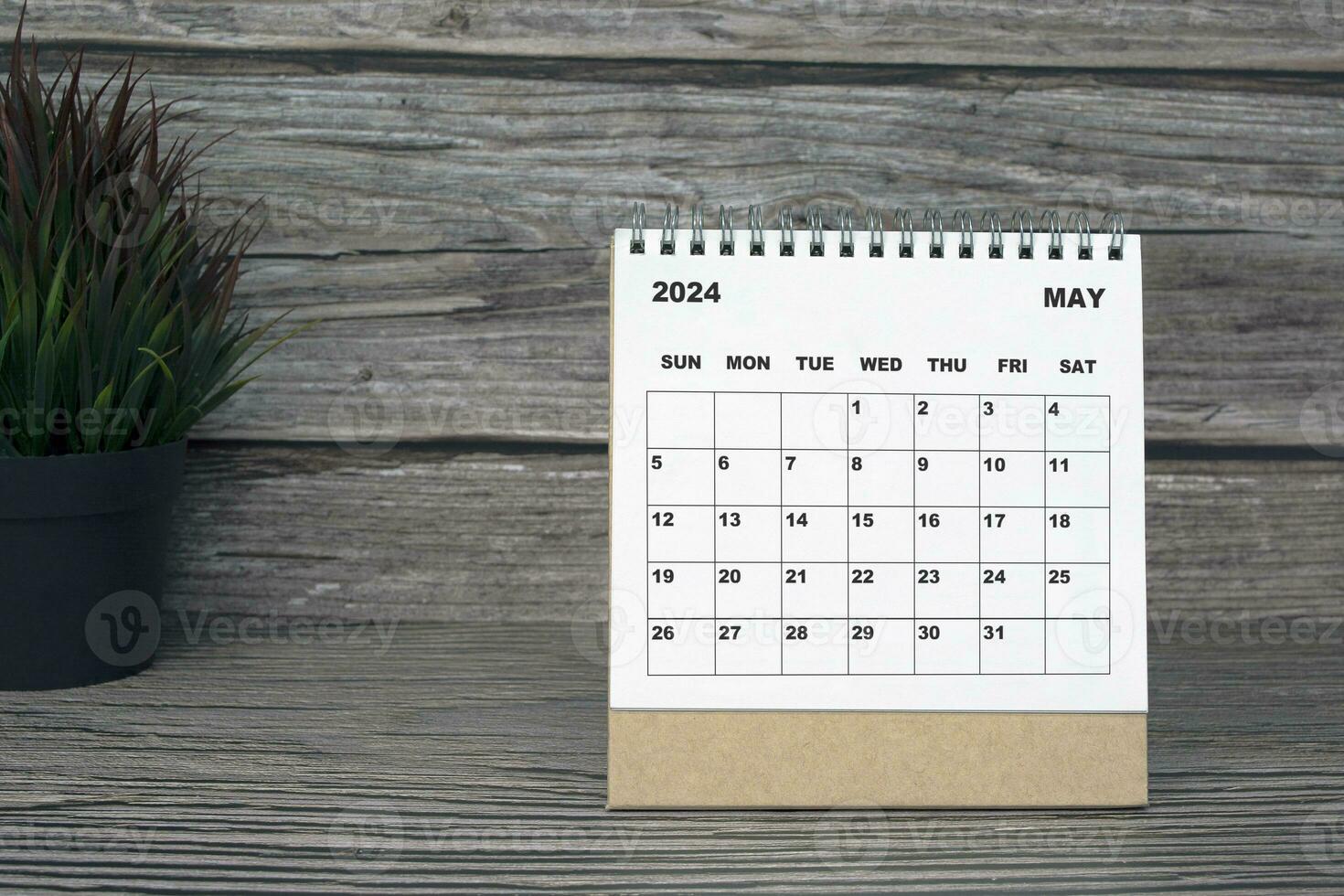 White May 2024 calendar on wooden desk. 2024 New Year Concept photo