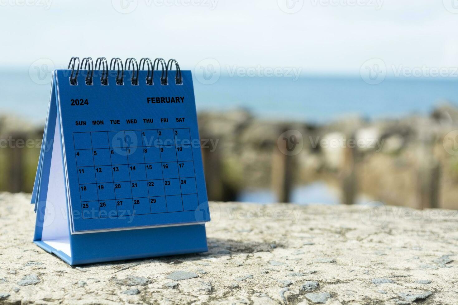 Blue February 2024 calendar on blurred background of blue ocean. New Year Concept photo