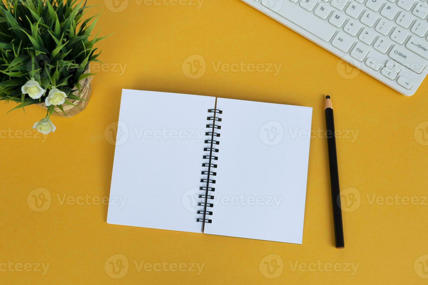 Directly above view of office desk with yellow background. Copy space. Flat lay. photo