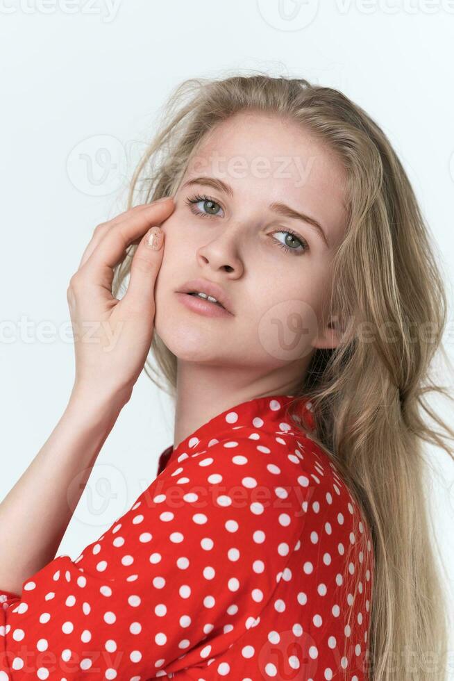 Portrait young blonde woman with long hair looking at camera. Female 21 years old, white background photo