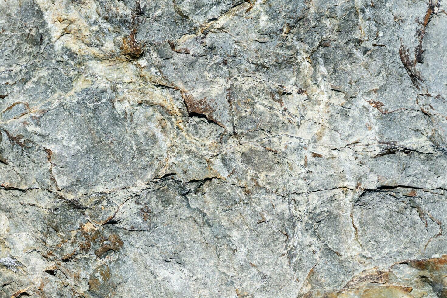 Cracked stone surface grey and brown color. Nature background or pattern texture photo