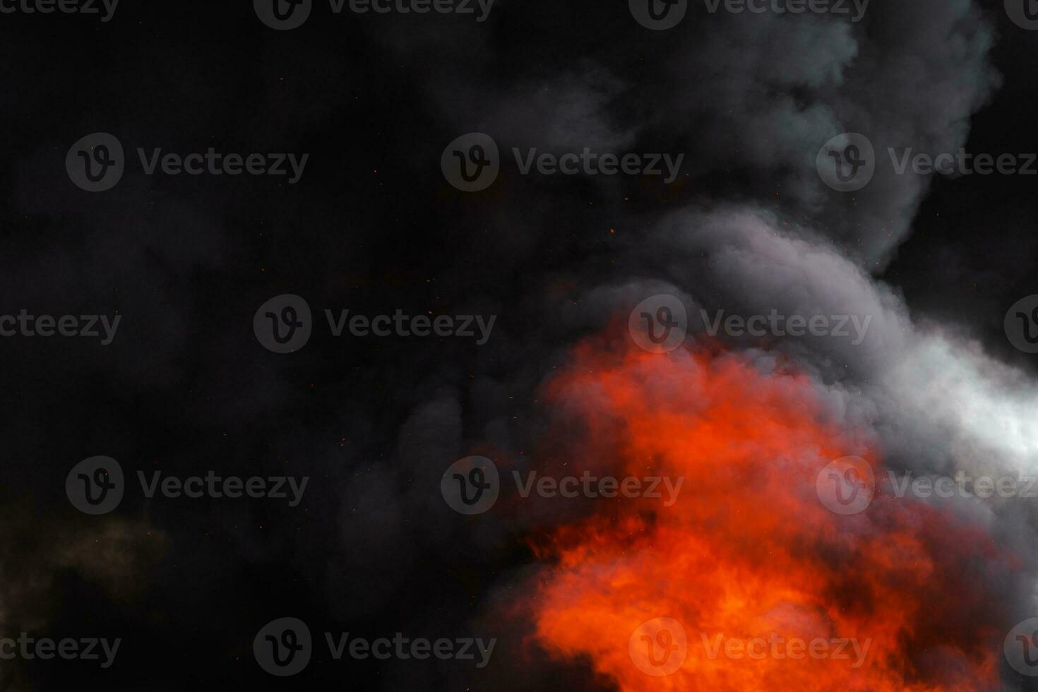 Flames strong red fire, dramatic clouds motion blur of black smoke covered sky photo