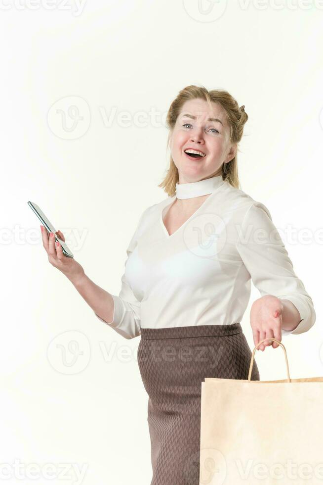 Ecstatic shopaholic women holding cell phone and shopping bags with purchases. Black Friday concept photo