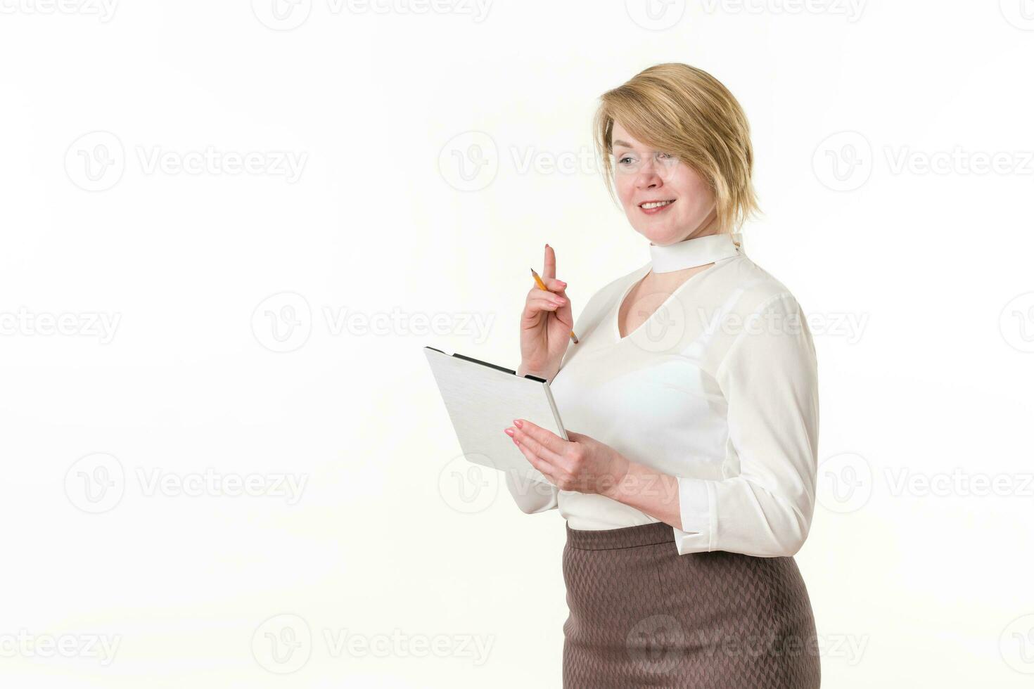 Smiling woman holds clipboard with pencil and happy looking away, standing against white background photo