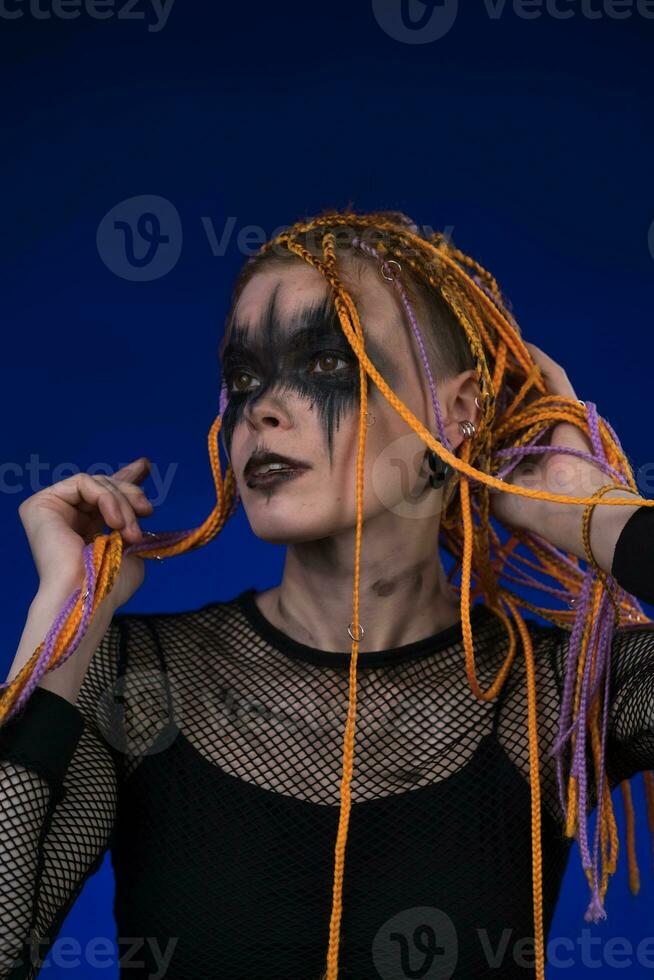 Cinematic portrait of woman with horror stage make-up and without dangerous dreadlocks hairstyle photo