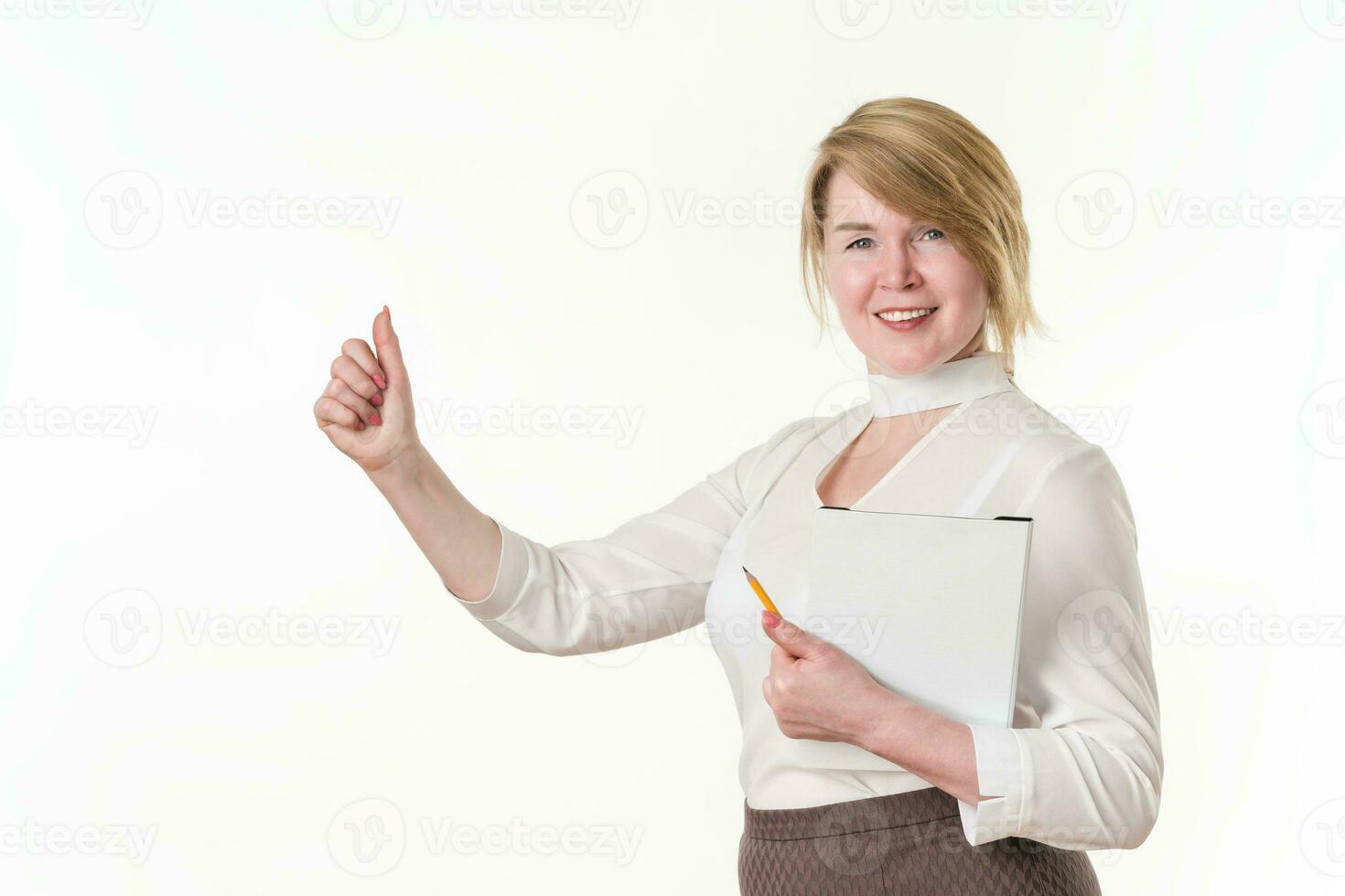 Smiling businesswoman showing thumbs up, holds clipboard and pencil. Business lady looking at camera photo
