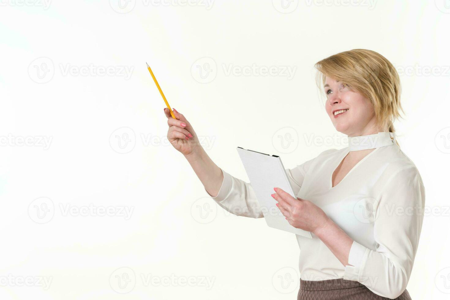 Caucasian ethnicity mature business woman holds clipboard pointing up finger with pencil. Copy space photo