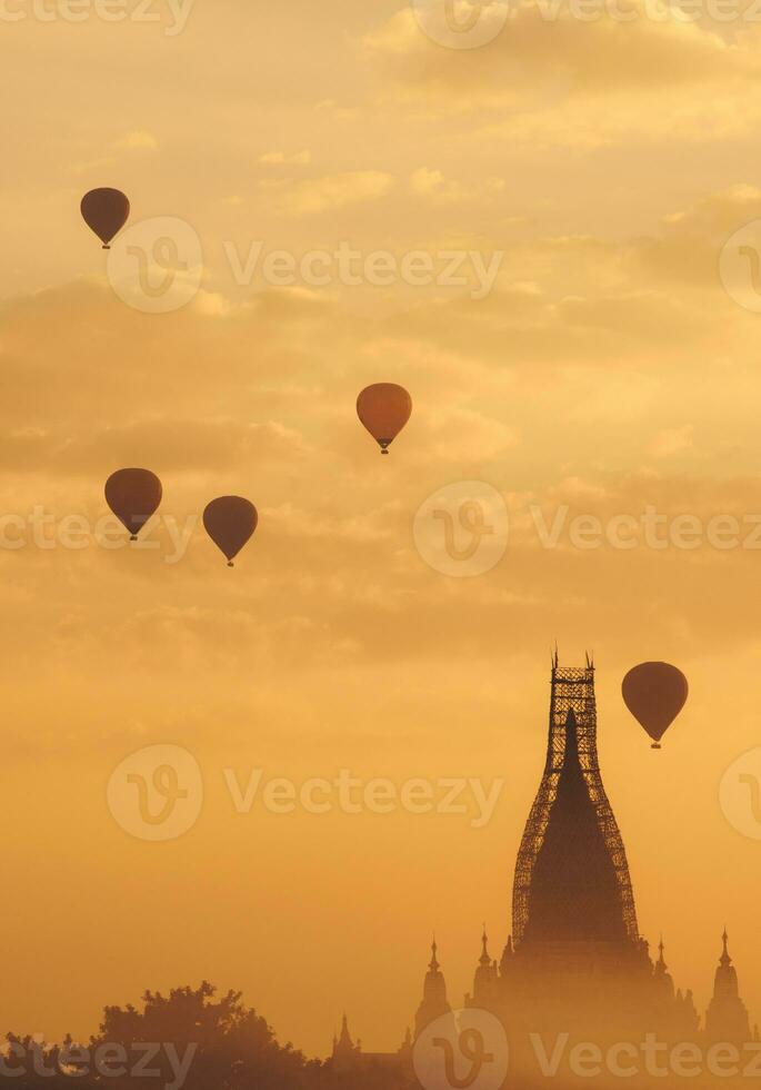Hot air balloons flying over the Ananda temple one of the most beautiful temple in Bagan, Myanmar. The temple is still repairing after damaged from the 2016 big earthquake. photo