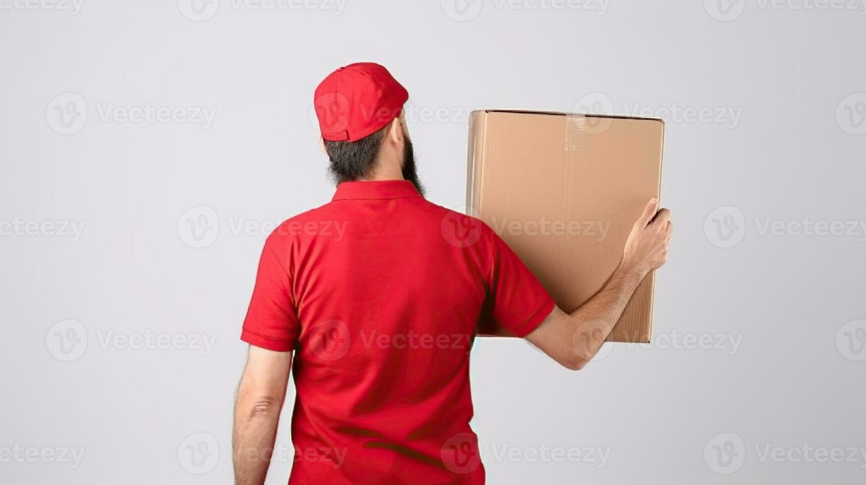 Young delivery guy wearing red uniform and cap holding the blank cardboard box over isolated white background. Generative AI photo