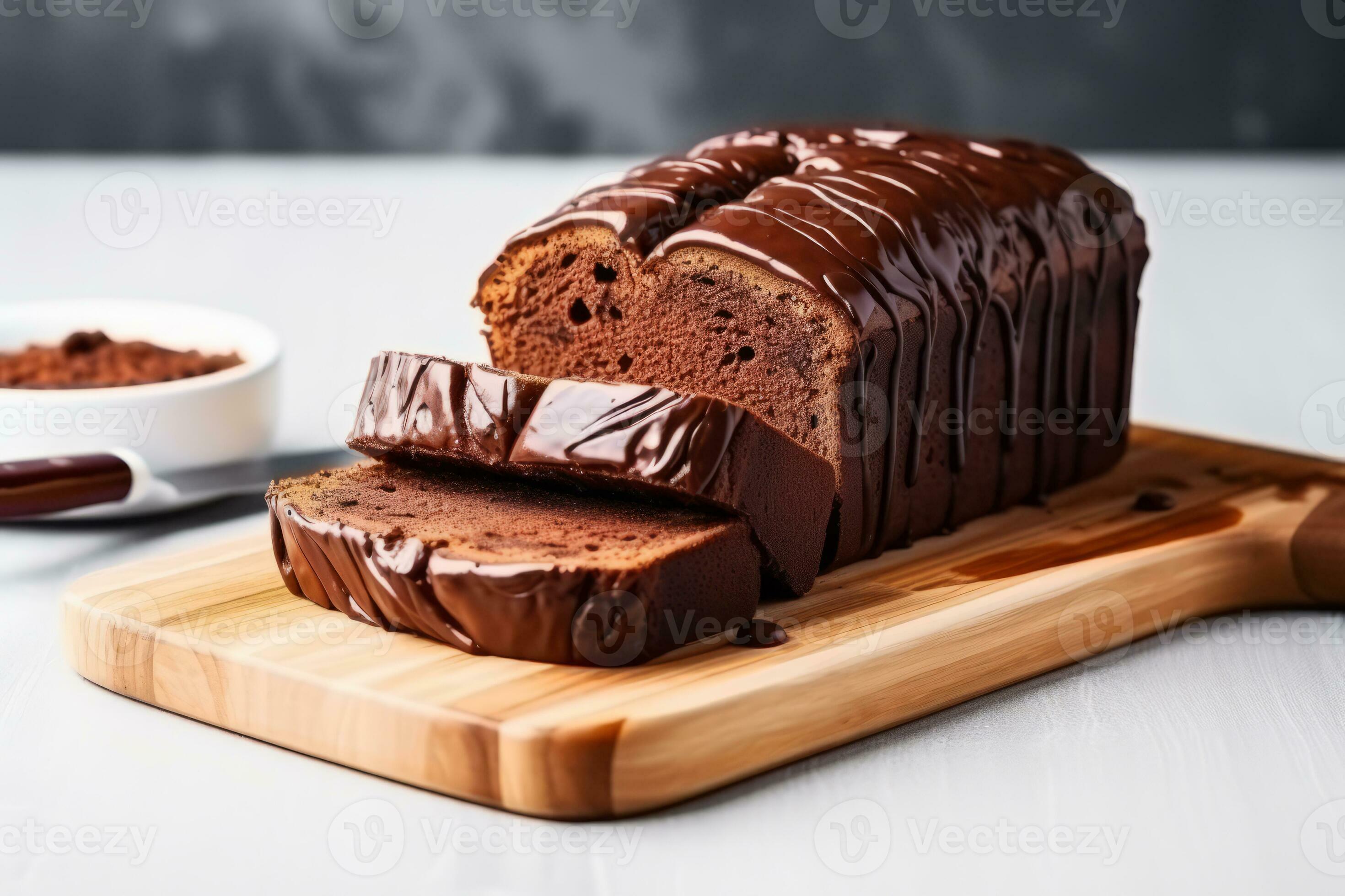 Chocolate pound cake. Loaf of cake sliced into pieces with chocolate