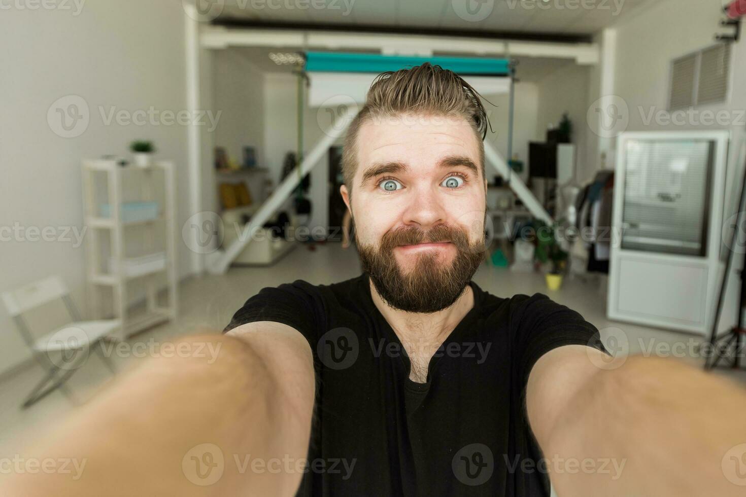 Happy bearded man taking selfie or having video call at home. Technology, people and lifestyle concept photo