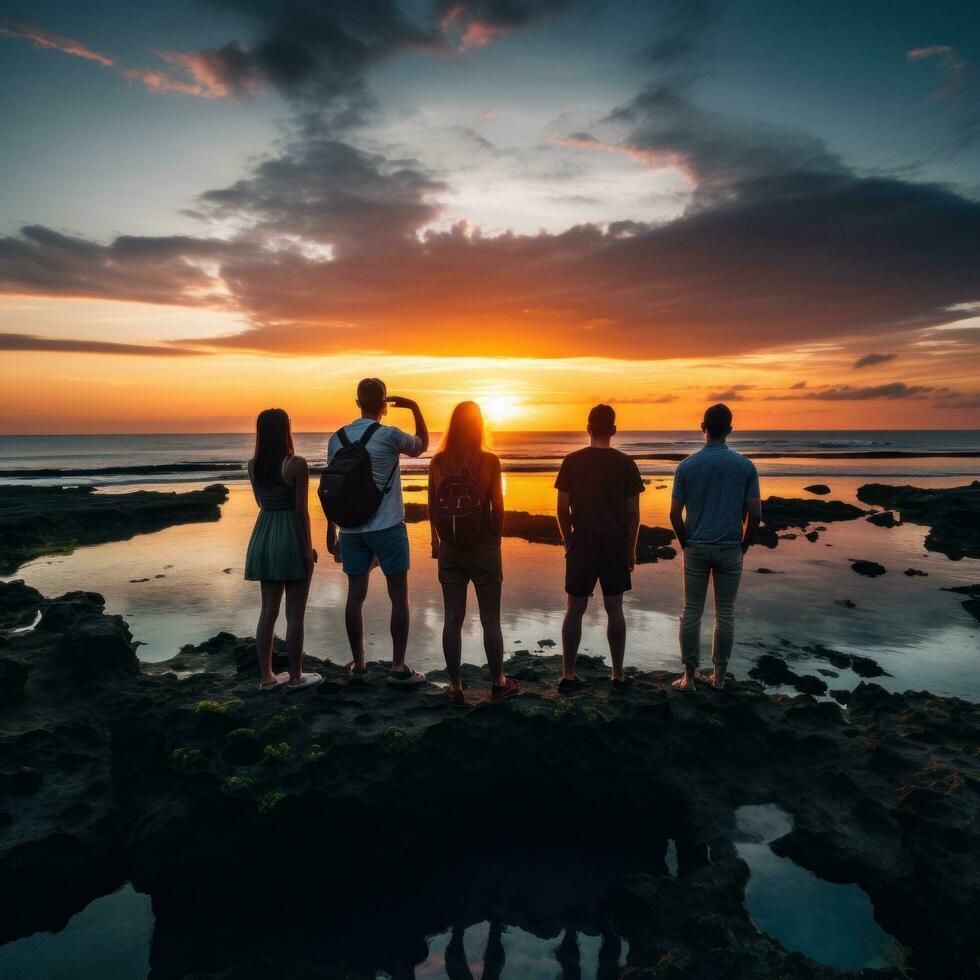 Captivating image of a group of travelers standing in awe of a stunning sunset photo