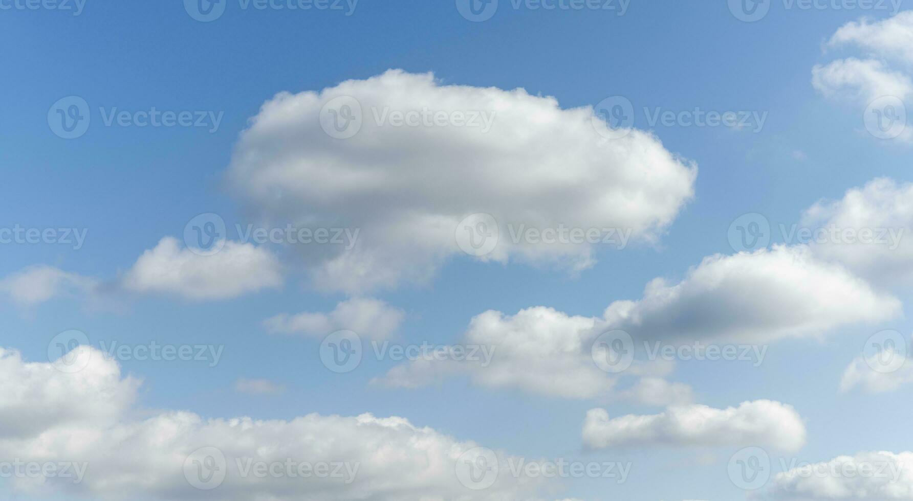 Blue sky background with tiny clouds photo