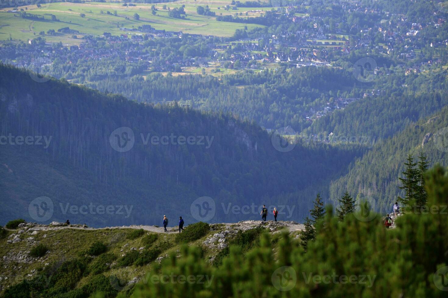 en medio de el asombroso tatra montañas en zakopane, Polonia, caminantes atravesar escénico caminos, inmerso en el impresionante belleza de de la naturaleza grandeza. con cada paso, ellos abrazo el sereno aventuras foto