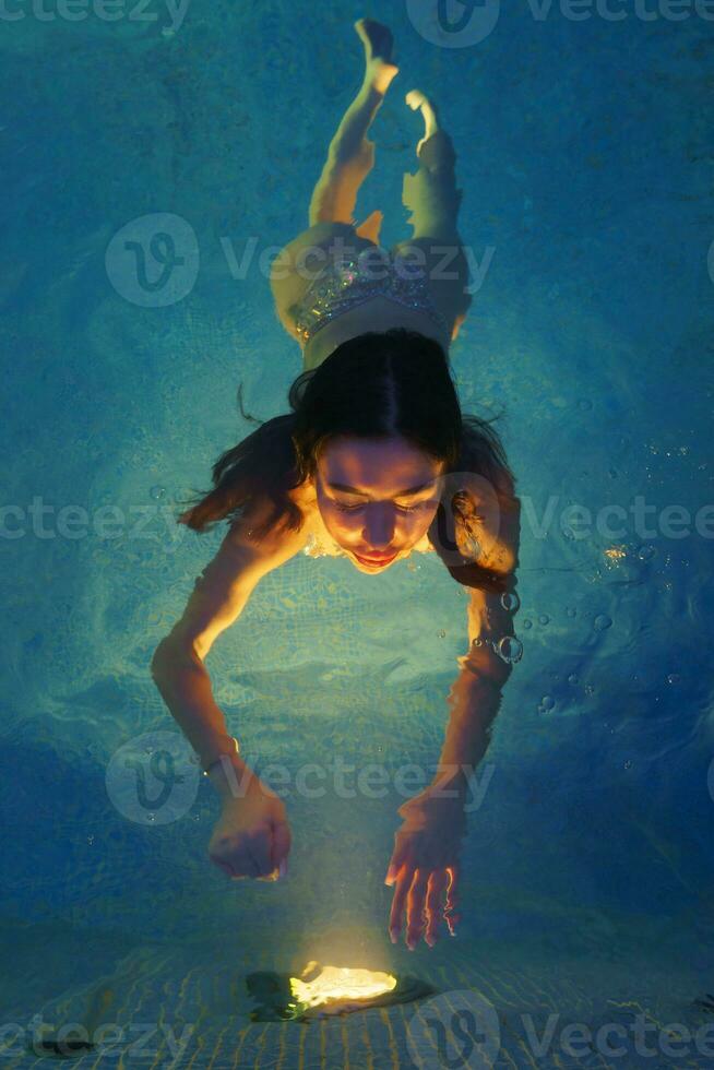 Extended sizes young woman in black swimming costume lying in