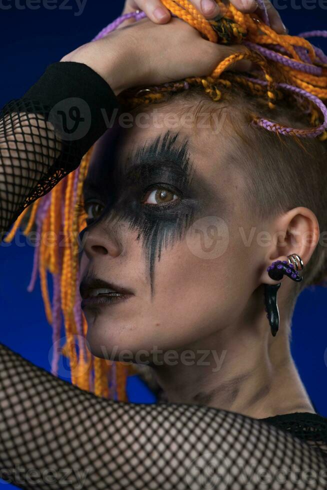 Dramatic portrait of young female with spooky stage makeup painted on face  and dreadlocks hairstyle 32500542 Stock Photo at Vecteezy