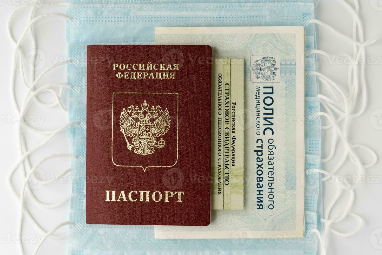 Passport of citizen Russian Federation, Compulsory Medical Insurance Policy, State Pension Insurance Certificate on background of face masks photo