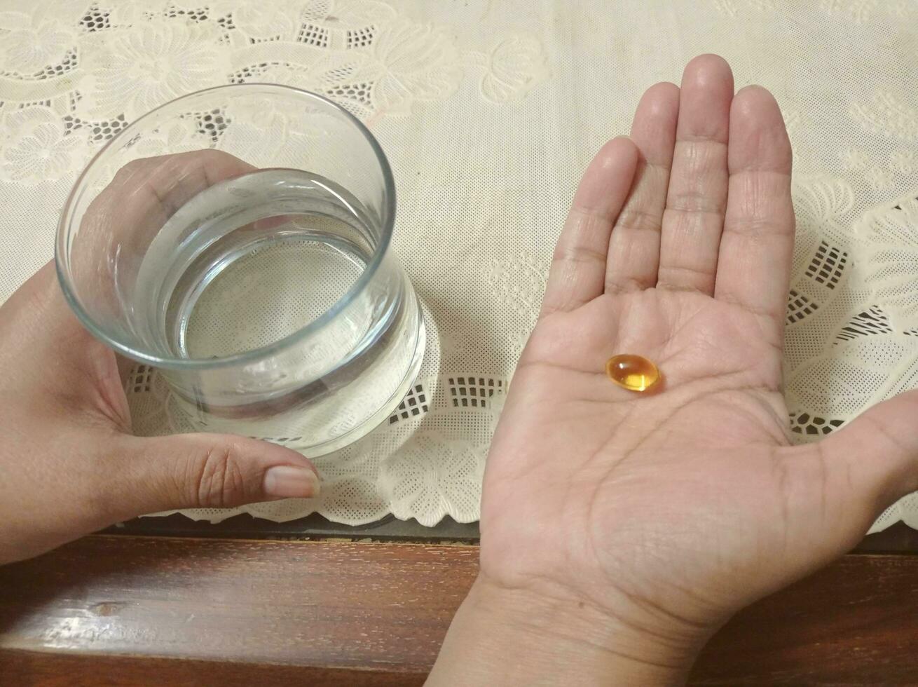 Taking medicine with glass of water photo