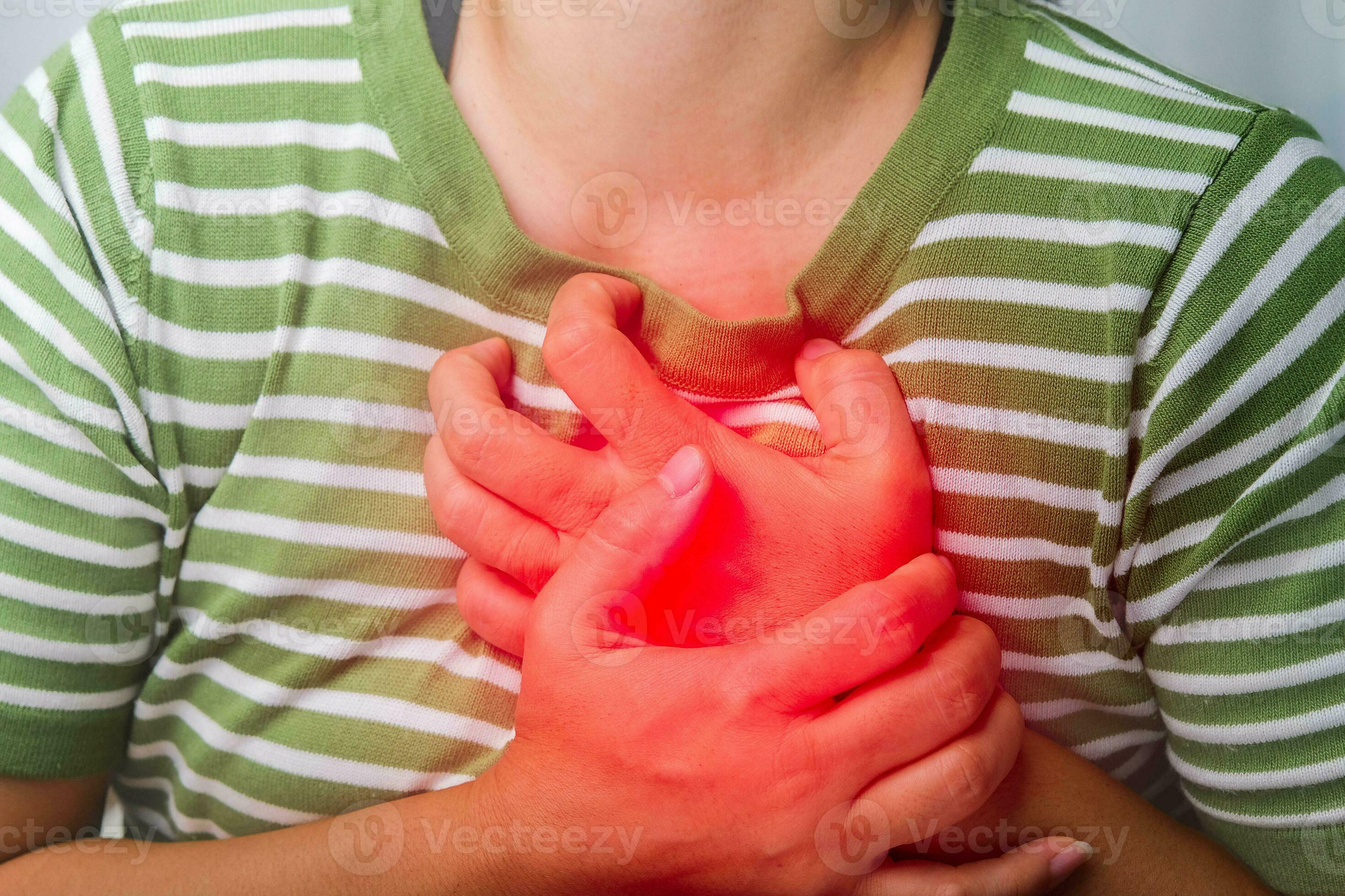 Woman holding her chest with a heart attack. Women have chest pain