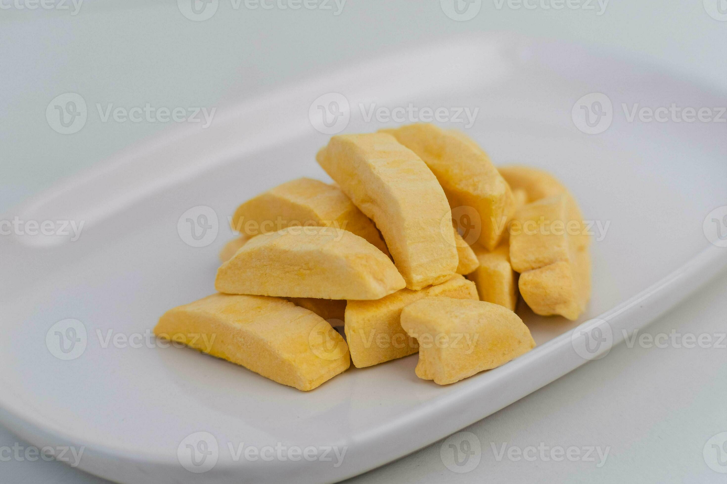 Healthy freeze dried fruits. Freezedried mango in plate on table